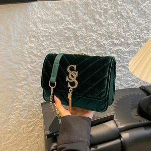 Luxurious dark green velvet crossbody bag with golden chain and tassel logo detail