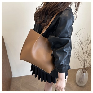 Detail of premium brown leather tote bag with elegant stitching and minimalist design