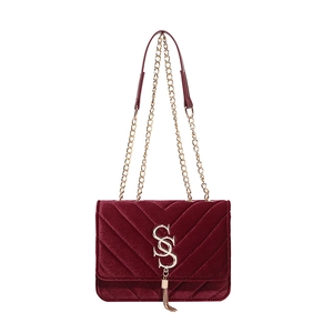 Elegant burgundy velvet crossbody bag with V-quilted pattern and gold chain strap