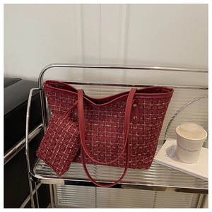 Detail of red tweed tote bag set with golden weave texture and matching pouch