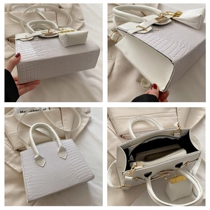Detail view of white crocodile pattern crossbody bag with golden hardware and inner liner