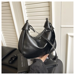 Detail showing the embossed Fashion & Bags lettering on this black leather hobo bag