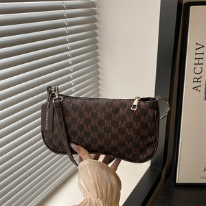 Brown monogram underarm bag with M pattern and leather strap in a stylish casual look