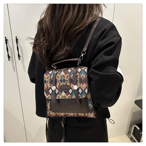 Detail view of colorful geometric diamond quilted backpack with premium leather accents
