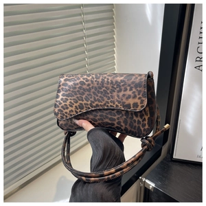Detailed view of the leopard print crossbody bag with stylish knotted shoulder strap detail