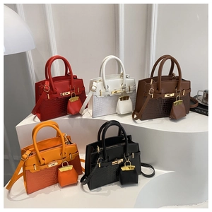 Detailed collection of crocodile pattern handbags in five colors on a display stand