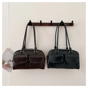 Detail of vintage leather shoulder bags in black and dark coffee with double front pockets