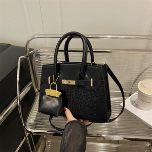 Chic black crocodile embossed handbag with gold hardware and mini pouch accessory