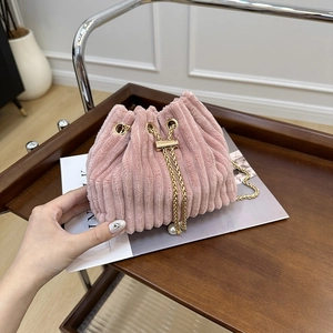 Pink corduroy drawstring bucket bag with gold chain strap and pearl accents