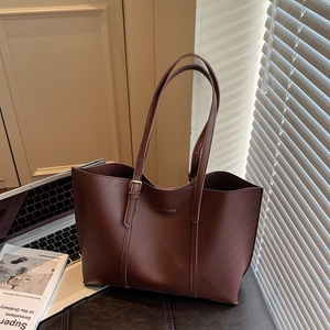 Retro dark brown large tote bag with adjustable straps and laptop in office setting