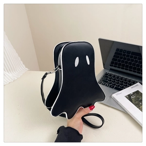 Detail view of the black ghost crossbody bag with white embroidery and zipper closure