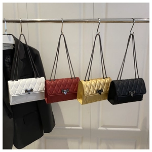Detail view of quilted cross body bags in four colors with metal chain and arrow lock