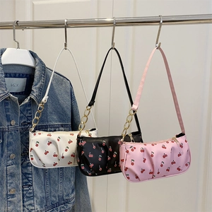 Trendy cherry print shoulder bags in white, black, and pink with gold chain details
