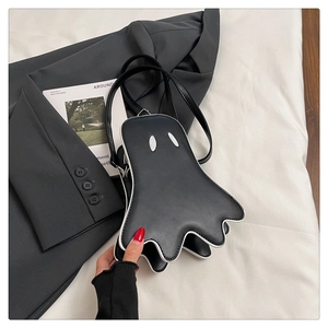 Close-up of cute ghost shaped crossbody bag in black PU leather with white edge trim