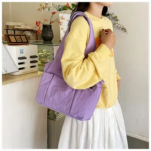 Side view of a large lilac purple tote bag with side pockets for daily commuting wear