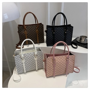 Classic patterned small tote bags in multiple colors shown on a geometric display stand