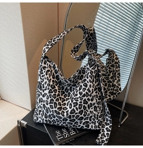 Detailed close-up of leopard print canvas tote with Fashion tag and durable stitching