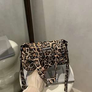 Y2K style leopard print underarm bag with silver studs and metal buckle detail