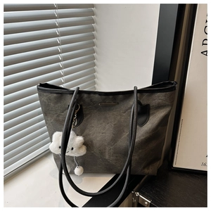 Detail of dark grey washed fabric tote bag with plush cloud charm and slim shoulder straps
