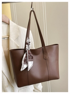 Brown large capacity leather tote bag detail with decorative silk scarf on handle