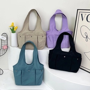 Fashionable pleated nylon tote bag with three front pockets in four stylish colors