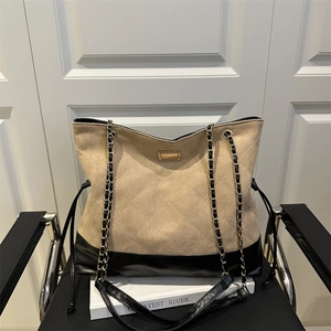 Quilted beige faux suede tote bag with black leather trim and gold chain straps