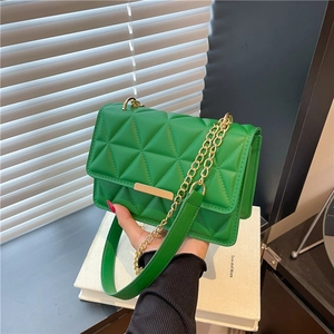 Minimalist green quilted chain crossbody bag with gold hardware and geometric embroidery
