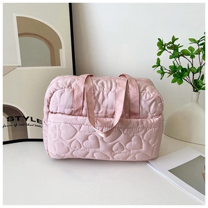 Pink quilted travel handbag with heart embroidery and lightweight nylon fabric detail