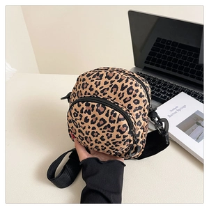 Detail showing high-quality leopard print canvas texture and durable double zipper pockets
