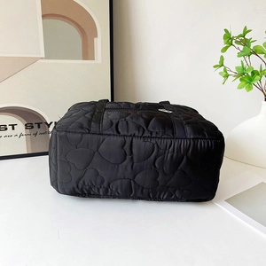 Chic black heart-quilted large tote bag for travel with zipper and top handles