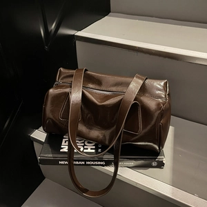 Retro dark brown cylinder shoulder bag in glossy oil wax leather with a top zipper closure