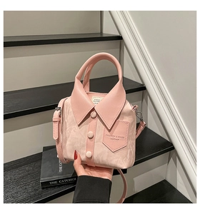 Detail of creative pink shirt-shaped bucket bag with collar, buttons, and shoulder strap