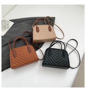 Detailed overhead view of quilted small square bags in beige, brown and black colors
