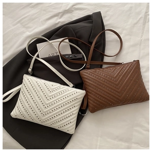 Detailed V-quilted envelope bags in cream and brown with metallic rivet studs and straps