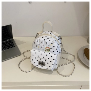 Detail of white mini polka dot backpack with chain strap and hamburger embroidery