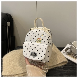 Close-up of white polka dot canvas mini bag with Tidal Dryness embroidery and burger design