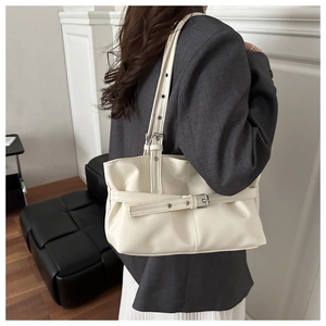 Détail du sac à bandoulière blanc crème en similicuir avec sangle à œillets sur mannequin