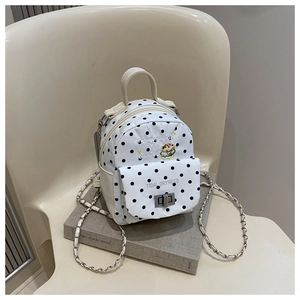 Detail of canvas mini backpack with polka dots, burger embroidery and chain strap