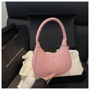 Pink crescent shoulder bag in a black gift box with luxurious white satin fabric lining