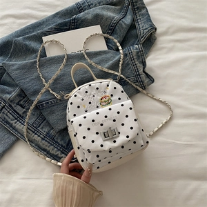 Minimalist white polka dot mini backpack with chain strap and burger patch detail