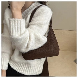 Detail of vintage brown leopard print hobo bag with silver zipper and suede texture
