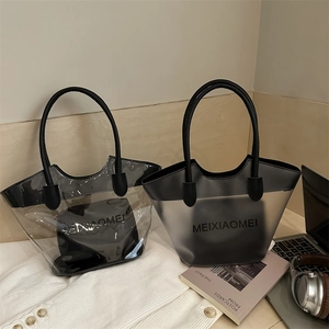 Transparent PVC tote bag with black inner pouch and round handles for casual commuting