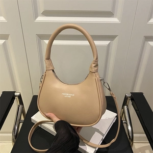 Chic beige hobo bag with gold lettering and adjustable crossbody strap for women