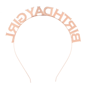 Close-up of rose gold birthday girl headband featuring textured metal lettering