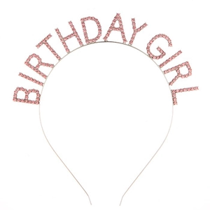 Detail of metal headband with pink rhinestones spelling Birthday Girl for party celebrations