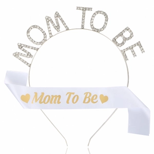 Detailed view of Mom To Be set with crystal headband and gold printed white satin sash