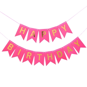 Detail of pink cardstock birthday banner with gold foil Happy Birthday lettering