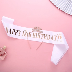Close-up of white 18th birthday sash with rose gold lettering and rhinestone headband