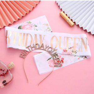 Detail of rose gold Birthday Queen sash and rhinestone tiara set on pink background