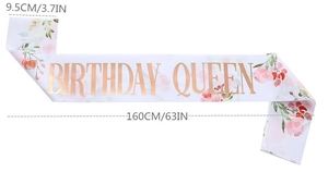 Detail showing white satin Birthday Queen sash with floral print and 160cm dimensions